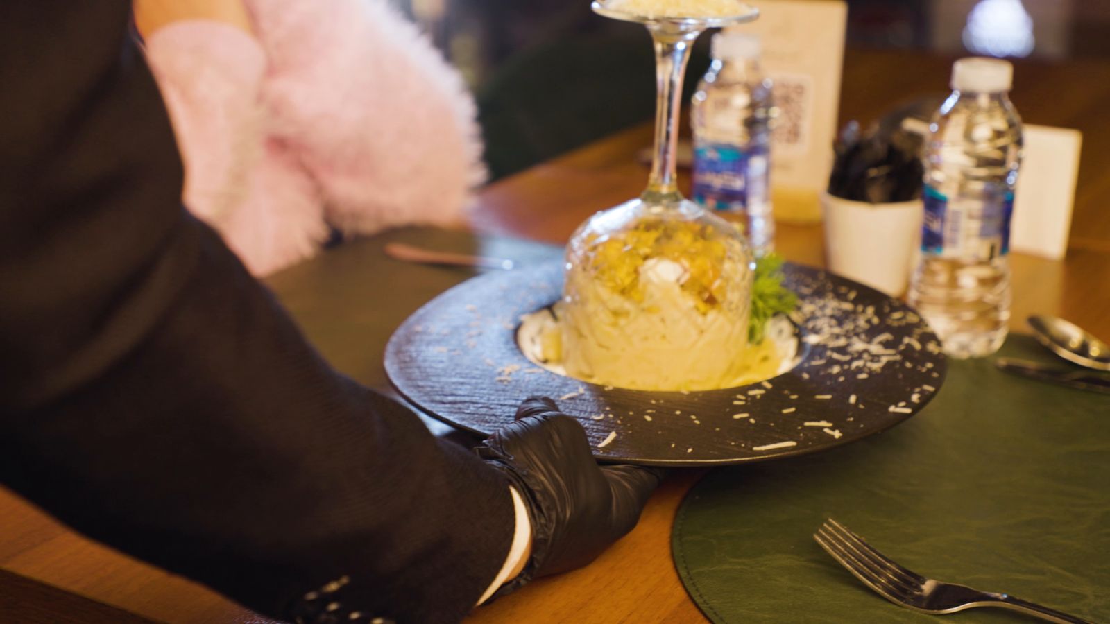 A creamy dish with grated cheese on a dark plate