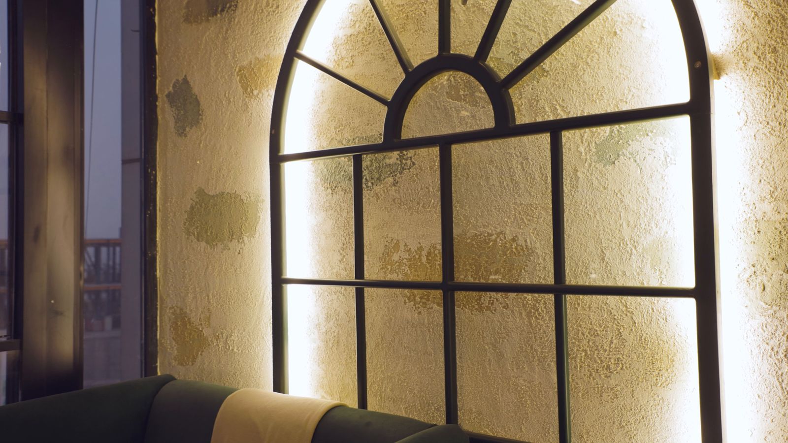 An arched window glowing in a warm restaurant interior