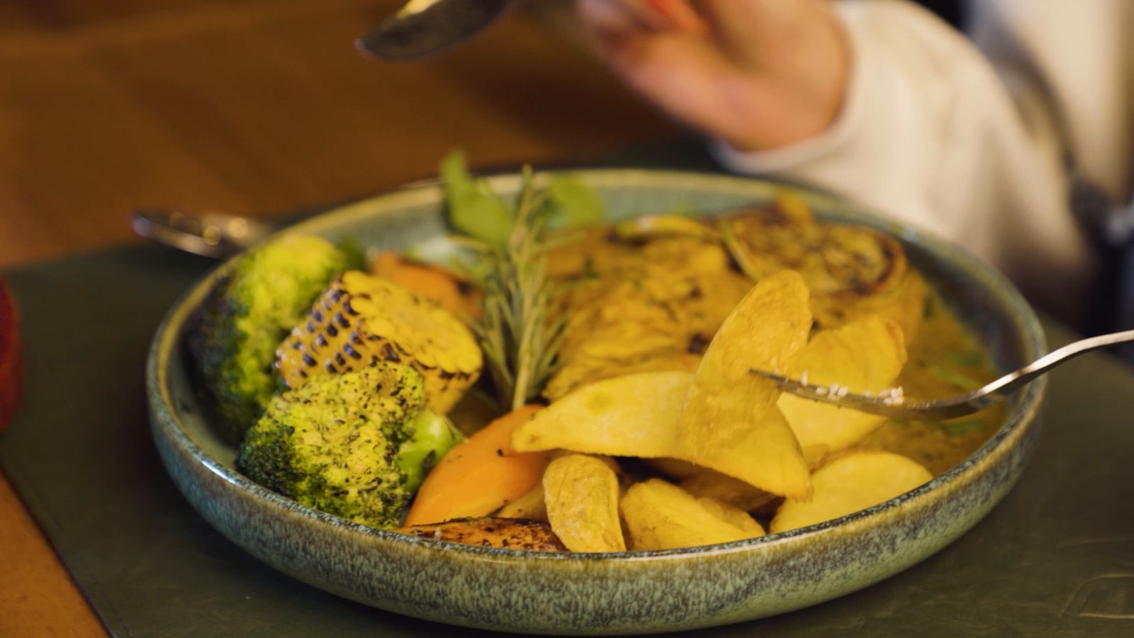 A rustic plate of roasted vegetables and potato wedges
